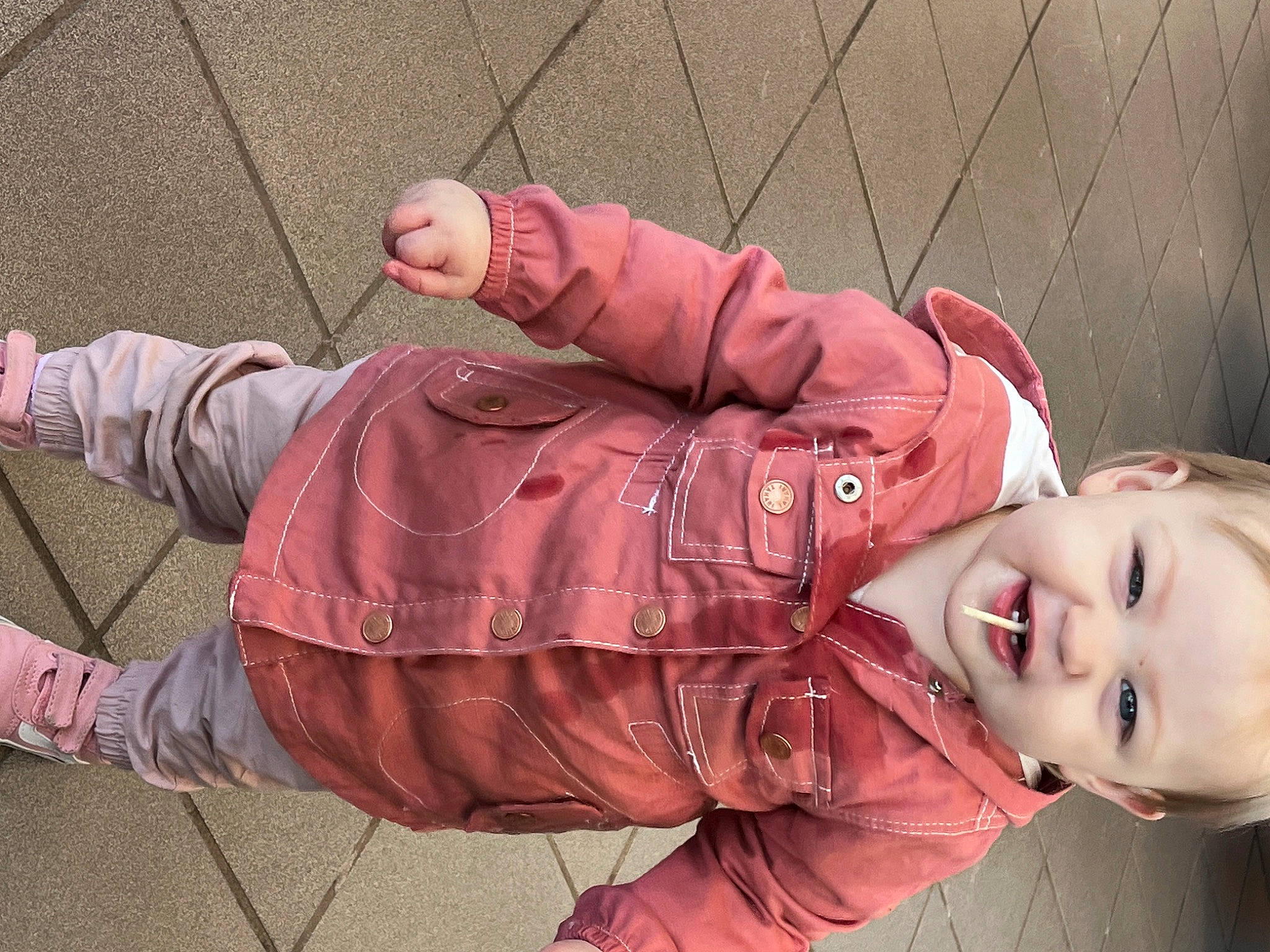 Finley joined the competition — help win amazing prizes! baby, child, clothing, flash_photography, foot, fun, grass, happy, human_leg, jacket, joy, pattern, person, pink, portrait_photography, sitting, skin, sleeve, smile, toddler