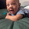 Sebastian is registered to the contest to win money with this photo: baby, infant, child, lying_down, bed, blanket, pacifier, onesie, cartoon_print, smiling, happy, face, skin, arm, hand, indoors, closeup, expression, cute, toddler