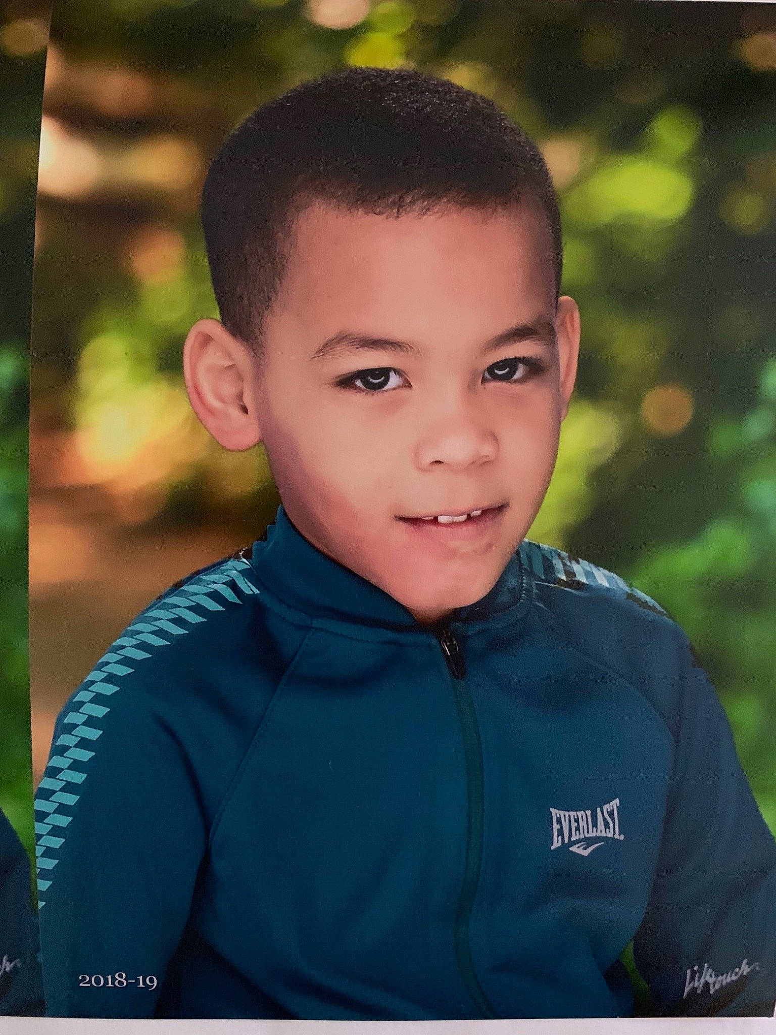 Josue is registered to the contest to win money with this photo: cheek, child, child_model, chin, eye, face, flash_photography, forehead, green, happy, head, male, people, person, photography, portrait, portrait_photography, smile, toddler, tree