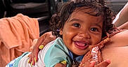 Julian joined the competition — help win amazing prizes! baby, child, curly_hair, smile, happy, indoor, window, rain, adult_hand, clothing, patterned_shorts, person, holding, cuddling, face, skin, joy, closeup, portrait, seat
