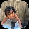 Julian joined the competition — help win amazing prizes! toddler, child, curly_hair, bare_chest, looking_up, floor, wooden_floor, striped_rug, hand_holding, footwear, indoor, person, skin, expression, candid, home, young_child, infant, grip, legs