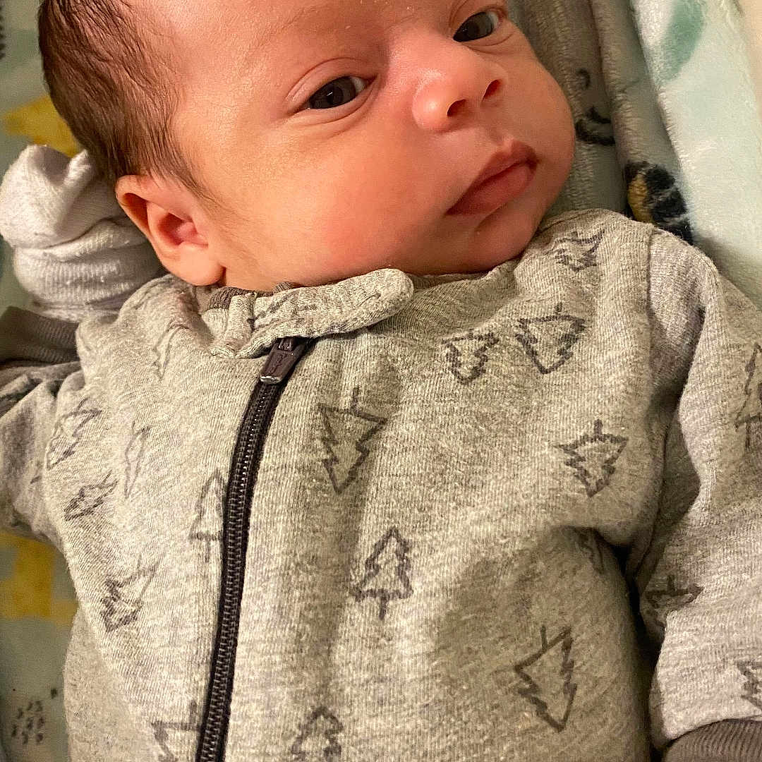 Niklaus joined the competition — help win amazing prizes! baby, blanket, clothing, coat, face, hair, happy, head, hoodie, jacket, knitwear, newborn, person, photography, portrait, quilt, sleeve, smile, sweater, sweatshirt