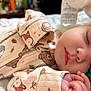 Nayeli is registered to the contest to win money with this photo: baby, sleeping, pacifier, onesie, animal_print, cozy, closeup, infant, peaceful, soft_light, hand, face, child, cute, bed, fabric, pattern, napping, skin, indoors