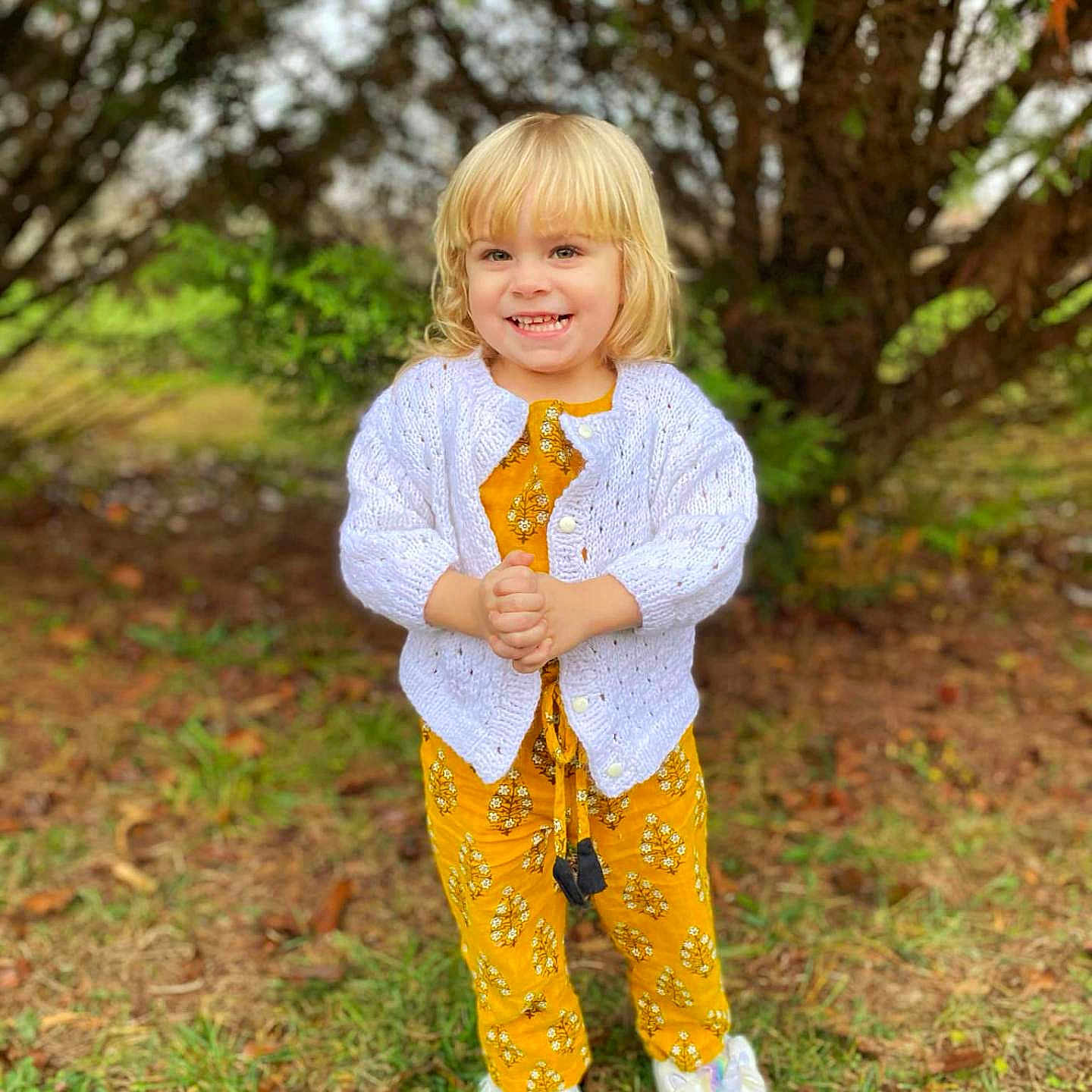 Shy joined the competition — help win amazing prizes! blonde, child, clothing, face, female, formalwear, girl, grass, hair, head, knitwear, pants, person, photography, plant, portrait, standing, sweater, tree, vegetation