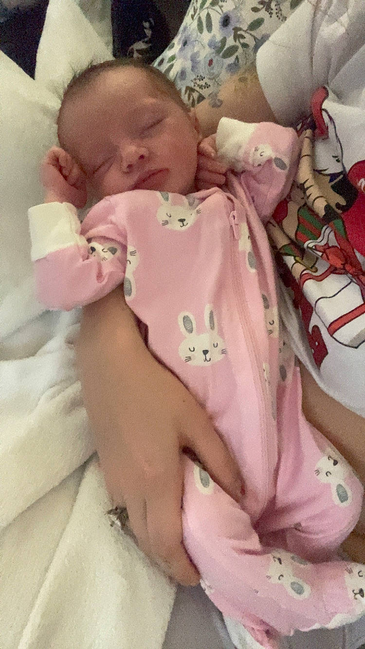 Izzybella joined the competition — help win amazing prizes! adult, baby, bed, blanket, bunny_pattern, closeup, clothing, cozy, cute, hand, indoor, infant, peaceful, person, pink_onesie, portrait, rest, sleeping, soft_lighting, toddler