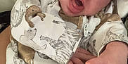 Izzybella is registered to the contest to win money with this photo: animal_print, baby, candid, child, clothing, cozy, curious, cute, expression, eyes, face, hand, indoor, infant, mouth, newborn, onesie, person, portrait, soft_surface