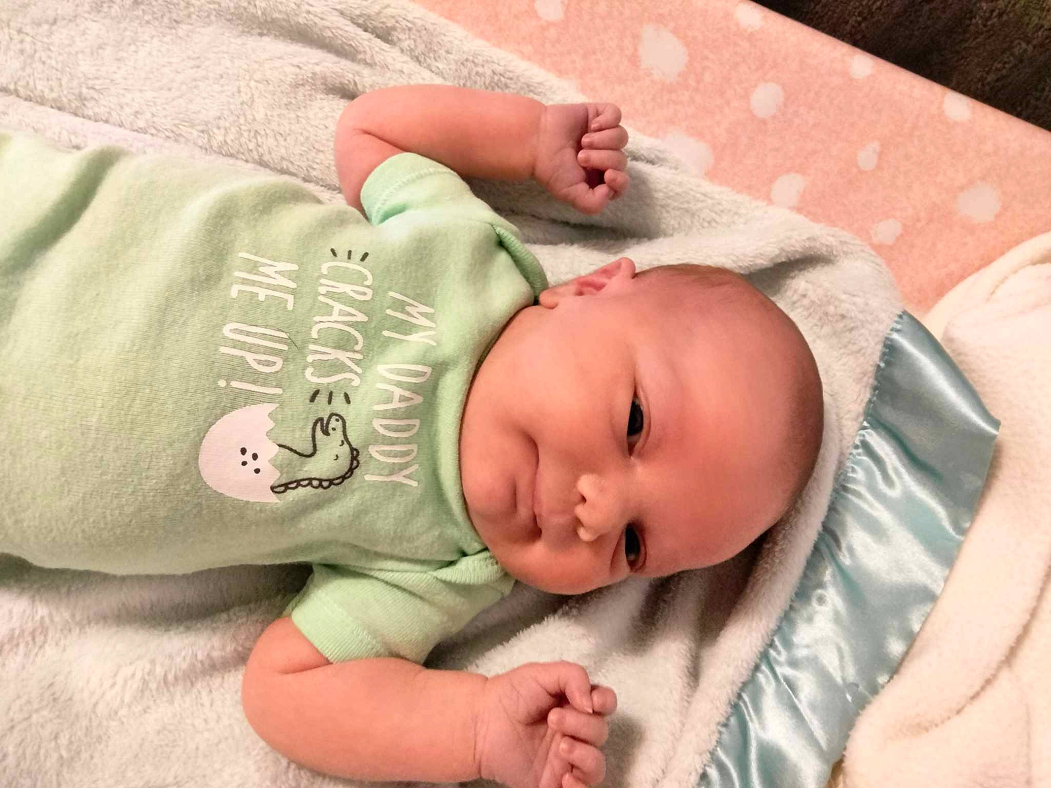 Leah is registered to the contest to win money with this photo: baby, baby_products, baby_safety, baby_sleeping, baby_toddler_clothing, bedtime, cheek, child, comfort, eye, face, grass, head, headgear, human_body, linens, person, skin, sleeve, toddler