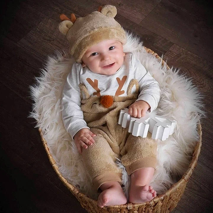 Drew is registered to the contest to win money with this photo: arm, baby, baby_products, baby_toddler_clothing, chair, comfort, costume_hat, flash_photography, foot, fur, fur_clothing, grass, happy, headwear, human_body, joy, lap, leg, person, sitting