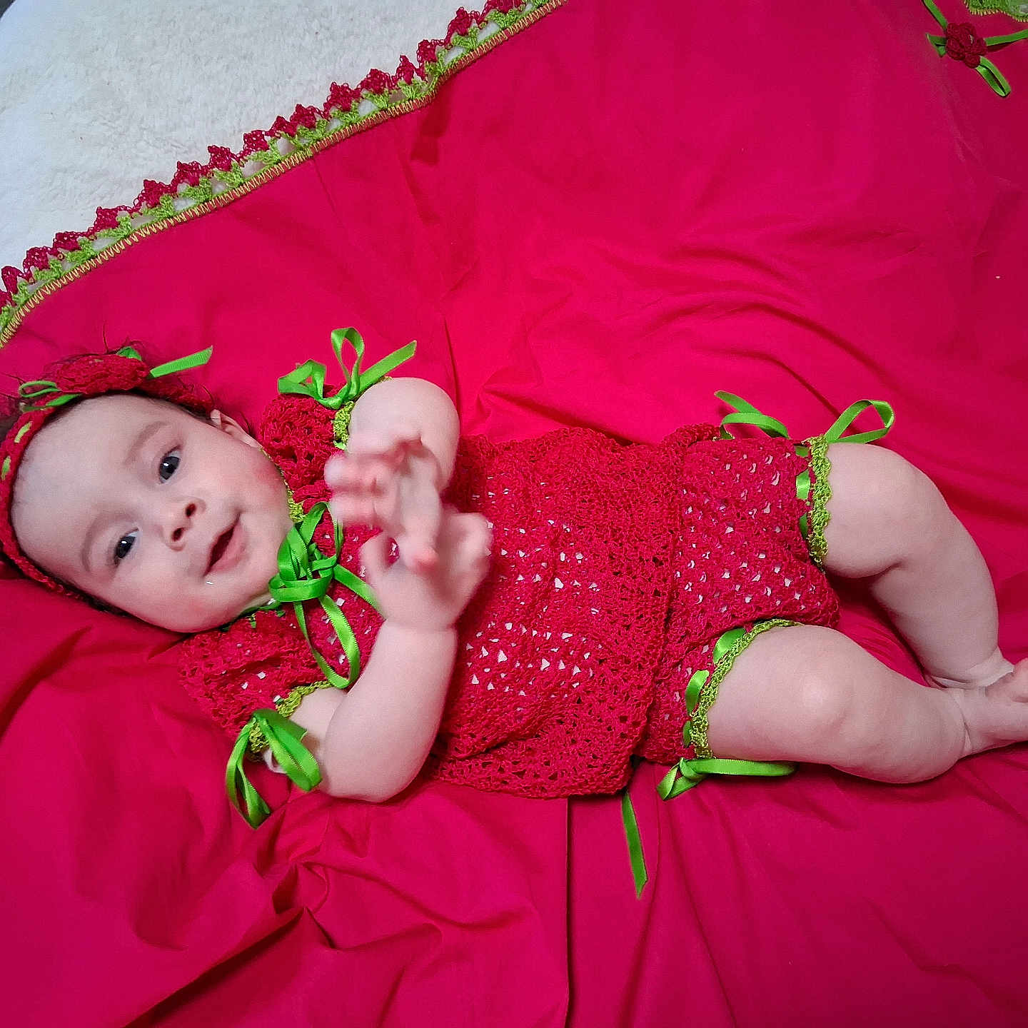 Mirelysbella joined the competition — help win amazing prizes! baby, infant, red_clothing, crochet, green_ribbons, lying_down, fabric, cute, smiling, hand, foot, headband, portrait, indoors, child, person, happy, skin, baby_girl, bright_colors