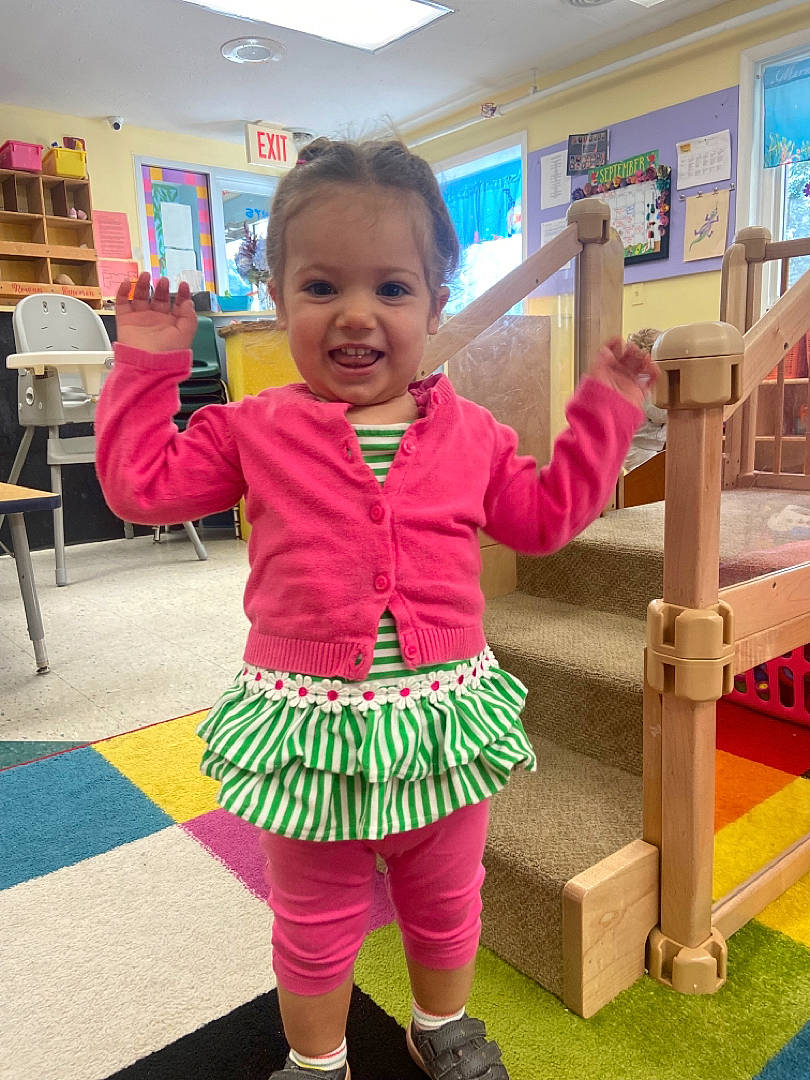 Dakota is registered to the contest to win money with this photo: baby, baby_toddler_clothing, child, event, facial_expression, fun, happy, human_leg, joy, leisure, magenta, person, pink, play, product, recreation, sleeve, smile, sock, standing