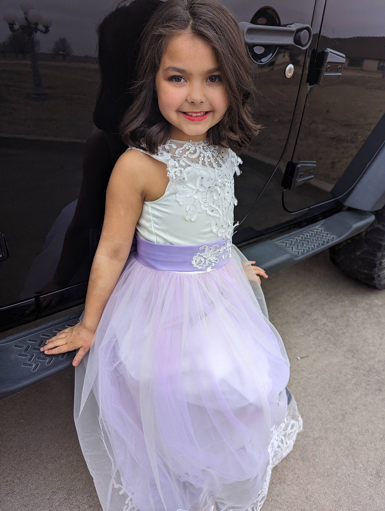 Briella joined the competition — help win amazing prizes! automotive_design, automotive_tire, bridal_party_dress, day_dress, dress, eye, face, fashion_design, flash_photography, formal_wear, hairstyle, happy, joy, long_hair, person, shoulder, smile, tire, toddler, vehicle_door