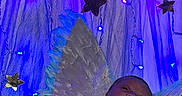 Kalyapea is registered to the contest to win money with this photo: angel, baby, blue_lights, celebration, cozy, cute, decorations, fairy_lights, feathers, golden_blanket, indoors, infant, magic, newborn, portrait, purple_lights, sleeping, soft_lighting, stars, wings