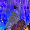Kalyapea is registered to the contest to win money with this photo: baby, infant, angel, wings, feathers, golden_blanket, purple_lights, blue_lights, stars, fairy_lights, newborn, sleeping, portrait, cute, soft_lighting, decorations, celebration, magic, cozy, indoors