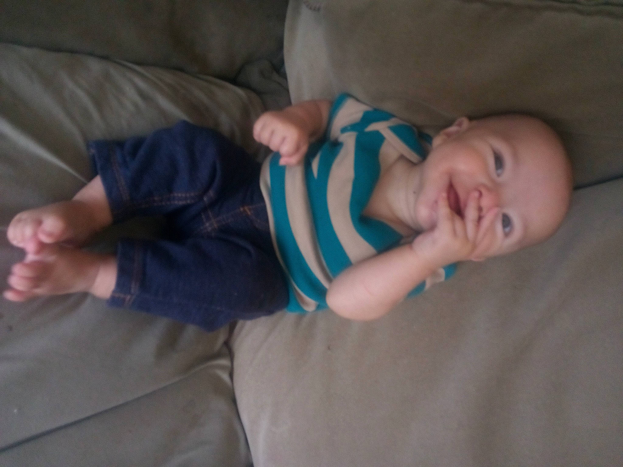 Andrew is registered to the contest to win money with this photo: baby, baby_toddler_clothing, cheek, child, comfort, elbow, eye, finger, gesture, head, human_body, human_leg, linens, person, room, sitting, skin, sleeve, thumb, toddler