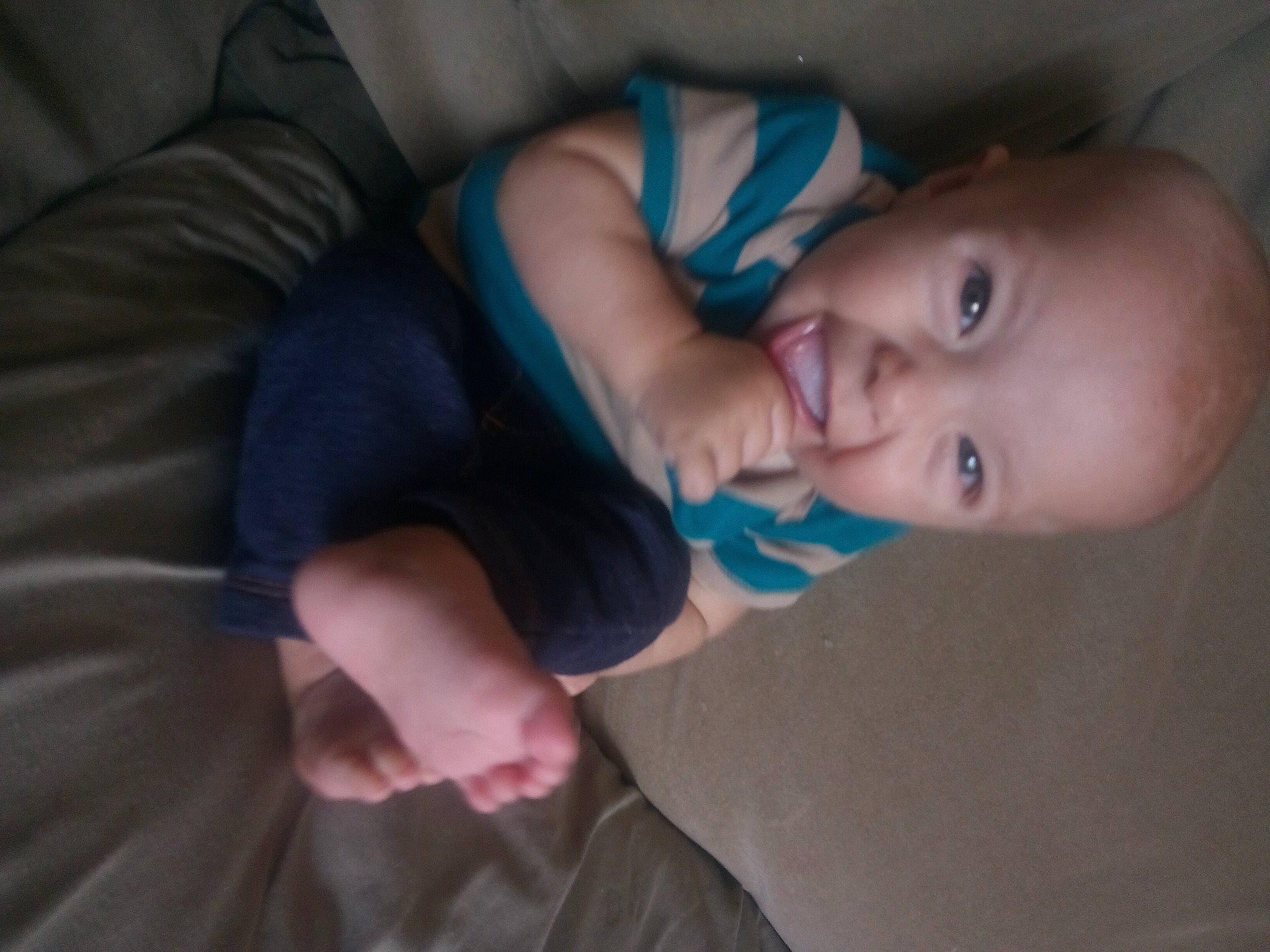 Andrew is registered to the contest to win money with this photo: baby, baby_toddler_clothing, cheek, child, comfort, elbow, electric_blue, finger, gesture, human_body, human_leg, iris, lip, mouth, nose, person, sitting, skin, sleeve, smile