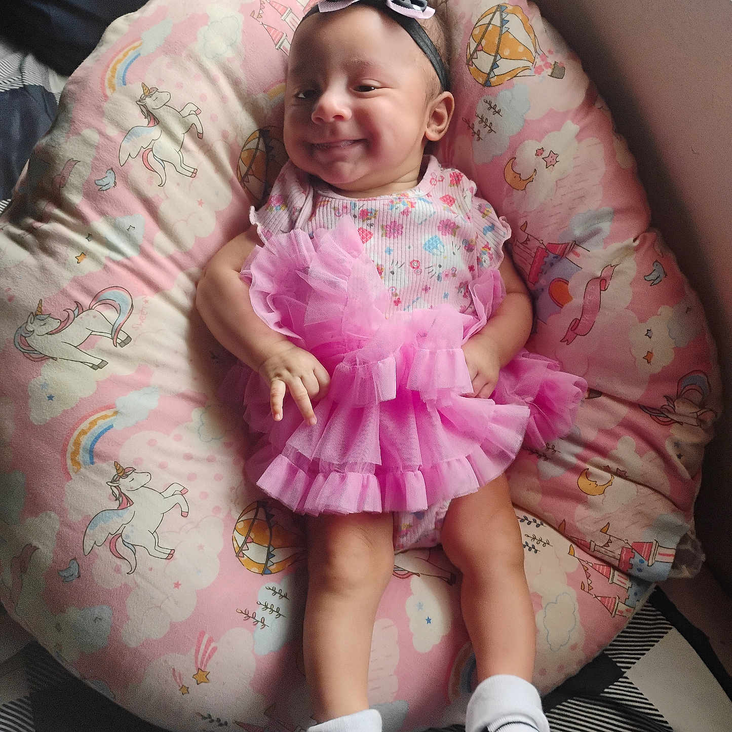 Anna Elsa is registered to the contest to win money with this photo: baby, infant, child, smiling, portrait, pink_dress, tutu, headband, bow, socks, sitting, cushion, unicorn, rainbow, nursery, indoor, cute, happy, fashion, closeup