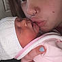 newborn, baby, person, face, sleeping, kiss, closeup, piercing, hand, nail_polish, hat, blanket, skin, love, tenderness, infant, parent, family, cozy, intimate