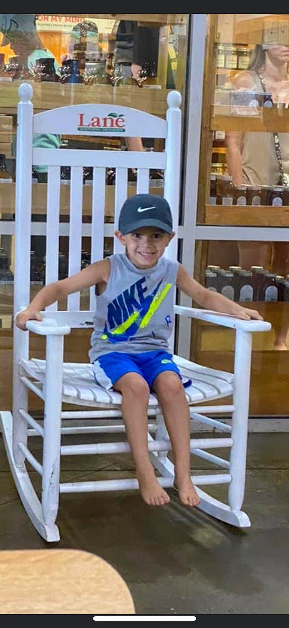 Oakland is registered to the contest to win money with this photo: baby_toddler_clothing, baseball_cap, cap, child, electric_blue, fun, happy, hat, headwear, human_leg, joy, knee, leisure, outdoor_furniture, person, product, shelf, shorts, smile, sun_hat