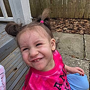 Freya joined the competition — help win amazing prizes! child, girl, pigtails, smile, outdoor, wooden_steps, fence, leaves, concrete, casual_clothing, pink_shirt, blue_pants, happy, portrait, person, sitting, daylight, playful, young, cute