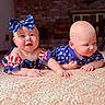 baby, infant, carpet, blue_bow, stars, stripes, patriotic, american_flag_colors, cute, smiling, lying_down, indoor, child, face, headband, red_white_blue, clothing, two_children, crawling, playful