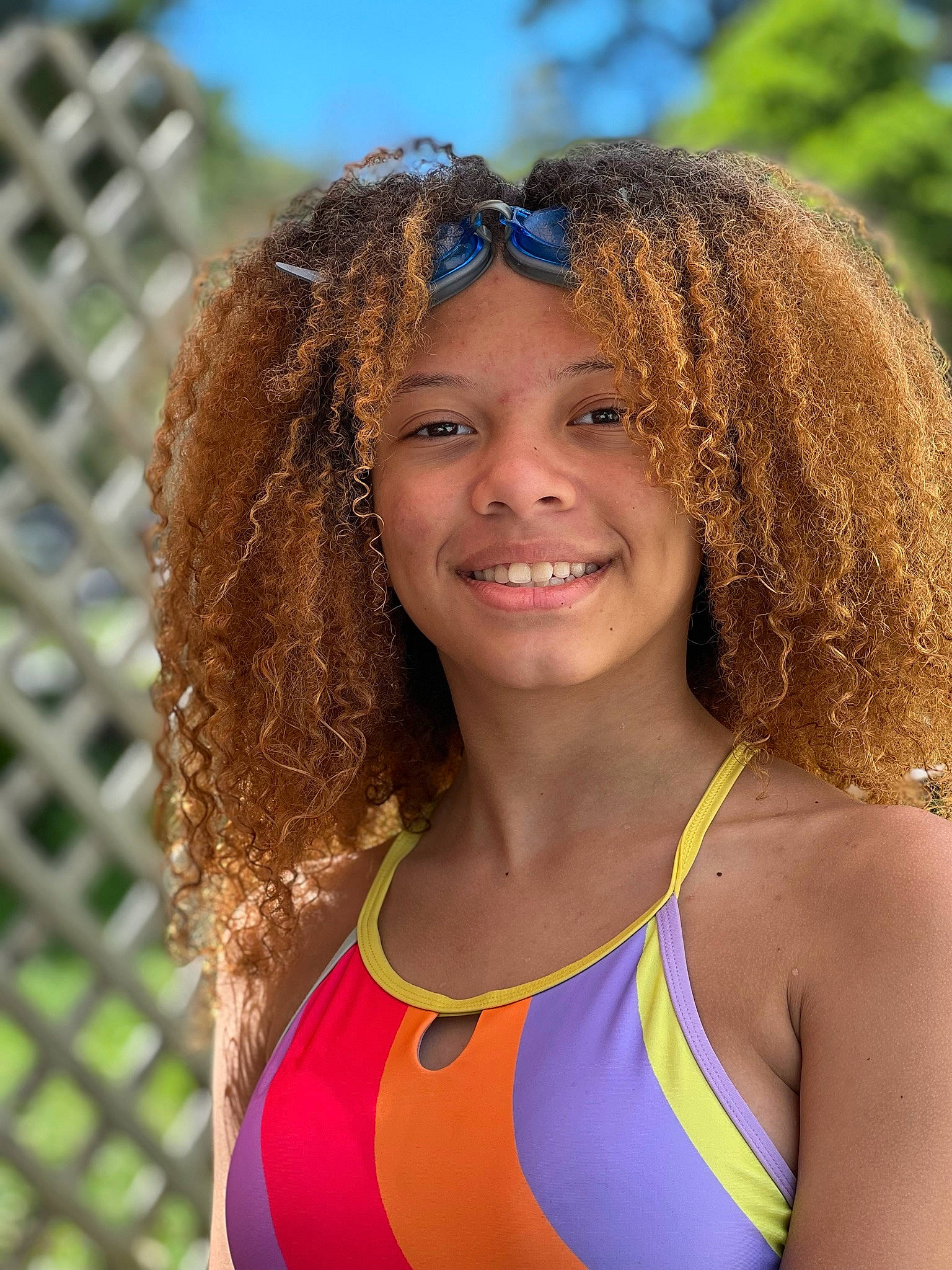 Allyssa is registered to the contest to win money with this photo: black_hair, chest, chin, clothing, electric_blue, eyebrow, face, goggles, grass, hair, hairstyle, happy, joy, leisure, lip, long_hair, people_in_nature, person, smile, swimwear