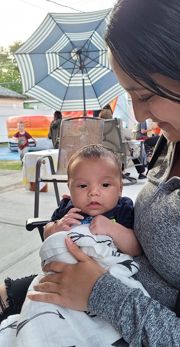 Oliver is registered to the contest to win money with this photo: baby, chair, child, event, fashion_accessory, fun, happy, interaction, leisure, person, photograph, product, sitting, skin, snapshot, summer, toddler, tree, umbrella, vacation