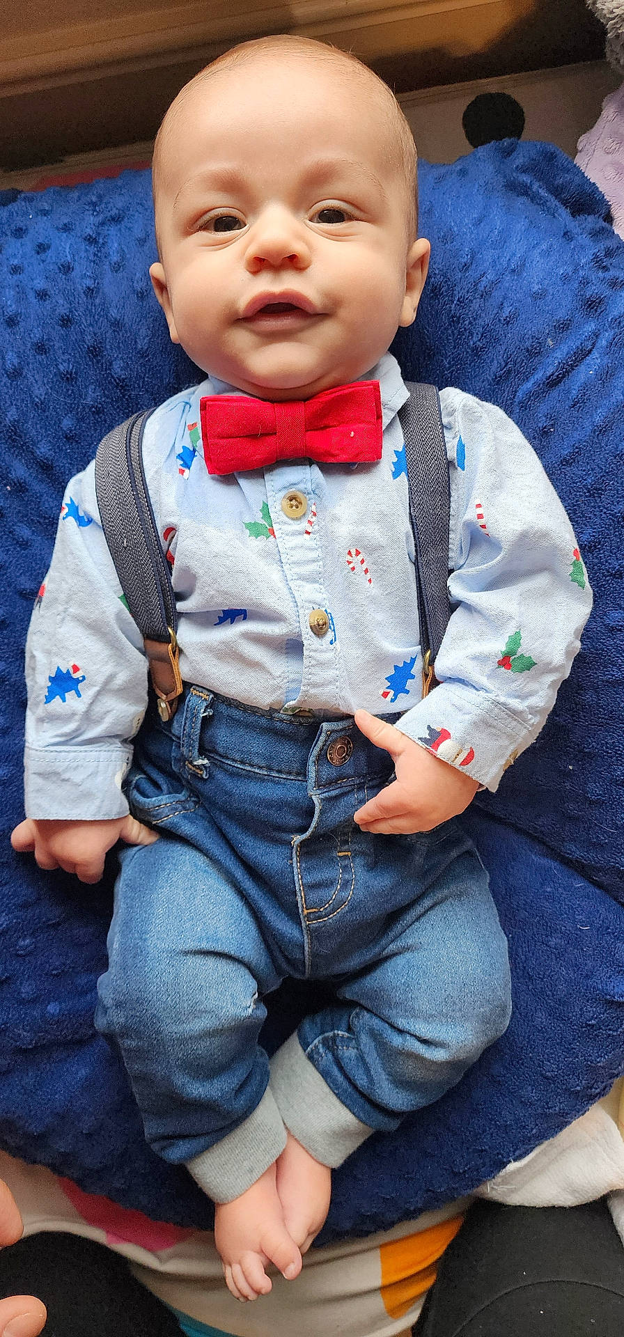 accessories, baby, clothing, coat, couch, cushion, face, formalwear, furniture, head, homedecor, jacket, jeans, pants, person, photography, portrait, suspenders, tie, vest