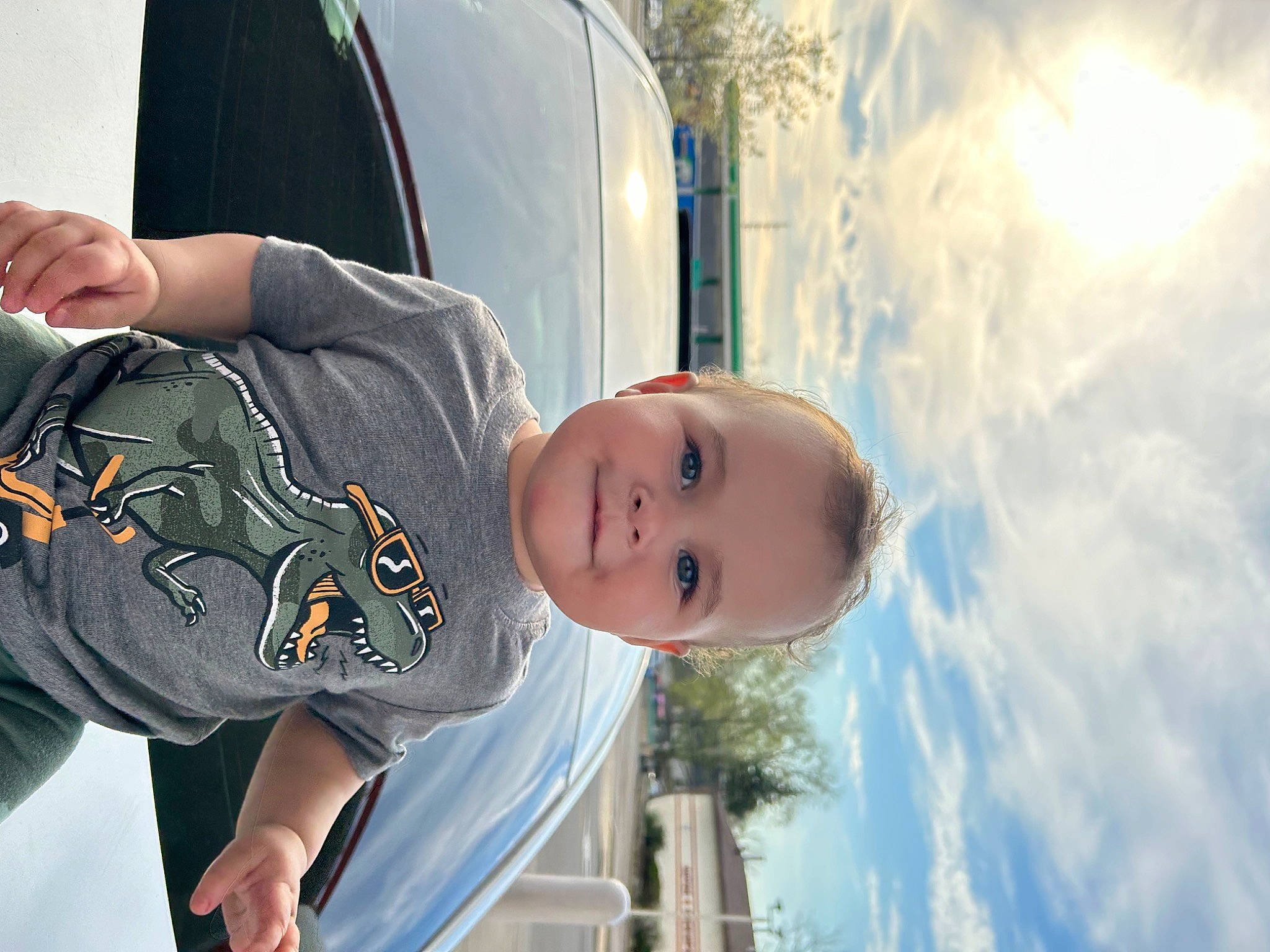 Lincoln is registered to the contest to win money with this photo: automotive_design, automotive_exterior, automotive_lighting, automotive_window_part, car, child, cloud, family_car, fun, hand, happy, joy, leisure, luxury_vehicle, motor_vehicle, person, sky, toddler, travel, tree