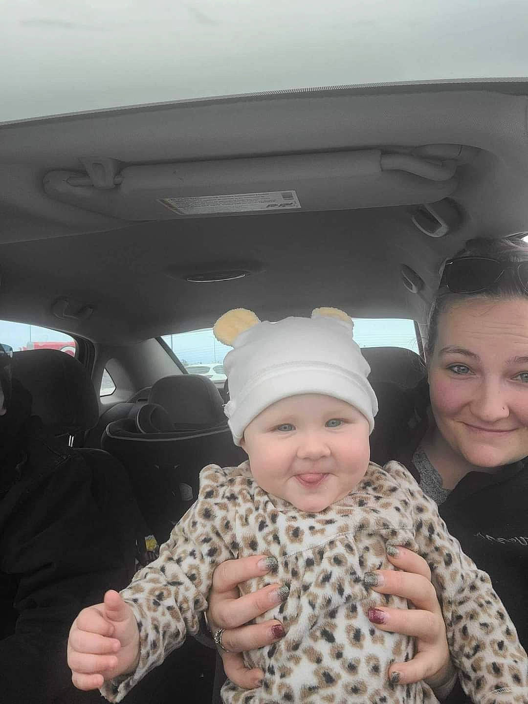 Novalee joined the competition — help win amazing prizes! auto_part, automotive_exterior, baby, cap, car_seat, cheek, child, family_car, fun, fur, gesture, happy, headwear, joy, luxury_vehicle, military_camouflage, pattern, person, smile, soldier