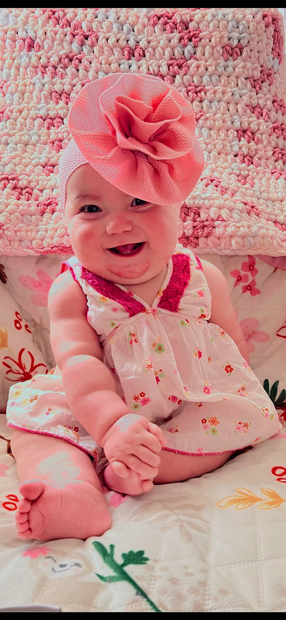 Bethany is registered to the contest to win money with this photo: baby, baby_laughing, baby_toddler_clothing, cap, child, fashion_accessory, fun, happy, headband, headpiece, headwear, joy, magenta, party_supply, pattern, peach, person, petal, pink, sitting