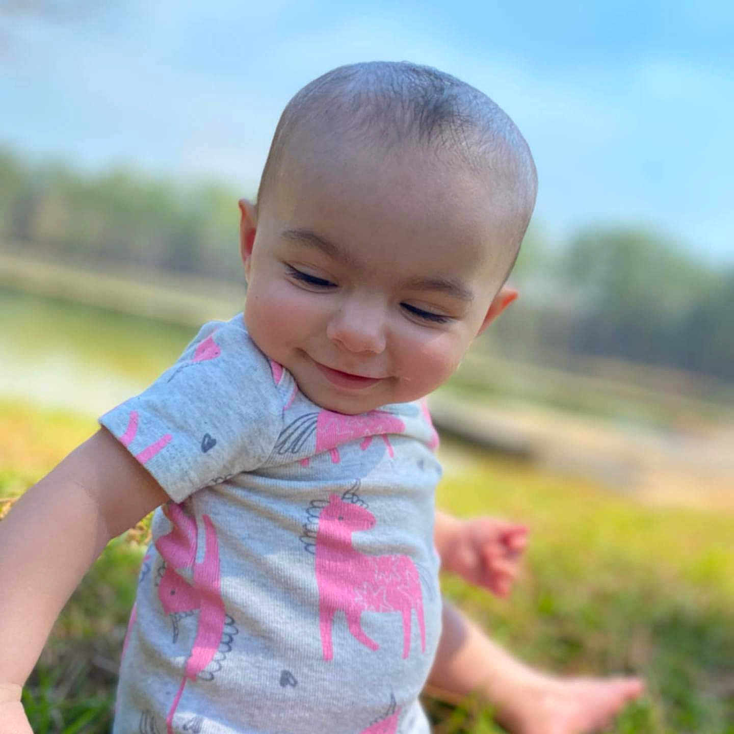 Kynzlynn joined the competition — help win amazing prizes! baby, child, cute, daylight, face, grass, happy, head, infant, nature, onesie, outdoor, person, portrait, sitting, skin, smile, sunny, unicorn, young