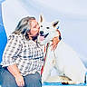 Véniziakaselupispei participe au concours pour gagner de l'argent avec cette photo : woman, dog, white_dog, pet, affection, kiss, happy, smiling, leash, plaid_shirt, casual_clothing, platform, advertisement, signage, outdoor, friendship, companionship, animal, portrait, event