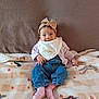 Elya a rejoint le concours — aidez-le/la à gagner de superbes lots ! baby, child, smiling, headband, bow, bib, jeans, pink_socks, blanket, animal_print, couch, seated, indoor, cute, clothing, portrait, happy, infant, soft_texture, casual