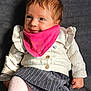 Elya a rejoint le concours — aidez-le/la à gagner de superbes lots ! baby, child, blue_eyes, pink_bib, white_sweater, striped_skirt, tights, cute, smiling, portrait, indoor, soft_lighting, ruffles, buttoned_clothing, sitting, young_child, fashion, cozy, warm_clothing, person