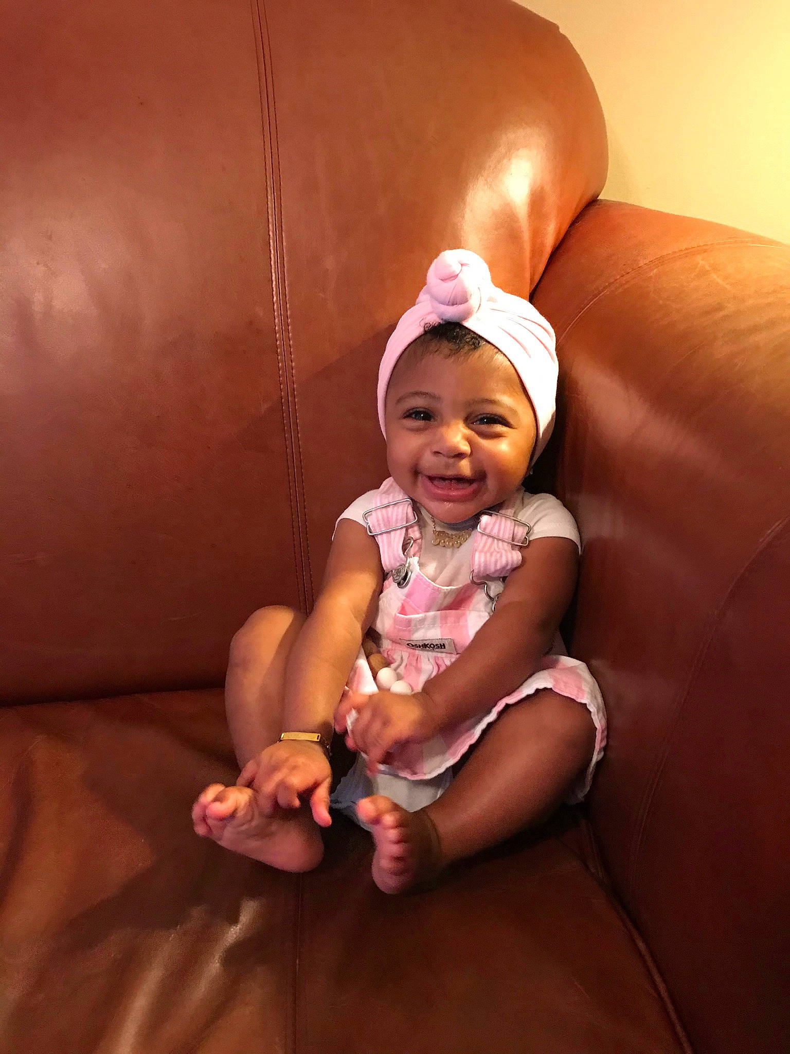 Kobe is registered to the contest to win money with this photo: baby, child, ear, finger, fun, joy, person, pink, sitting, skin, smile, thumb, toddler