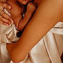 Dominic is registered to the contest to win money with this photo: baby, infant, child, person, skin, hand, arm, tattoo, fabric, silk, texture, portrait, closeup, cuddle, love, warmth, skin_tone, expression, eyes, holding