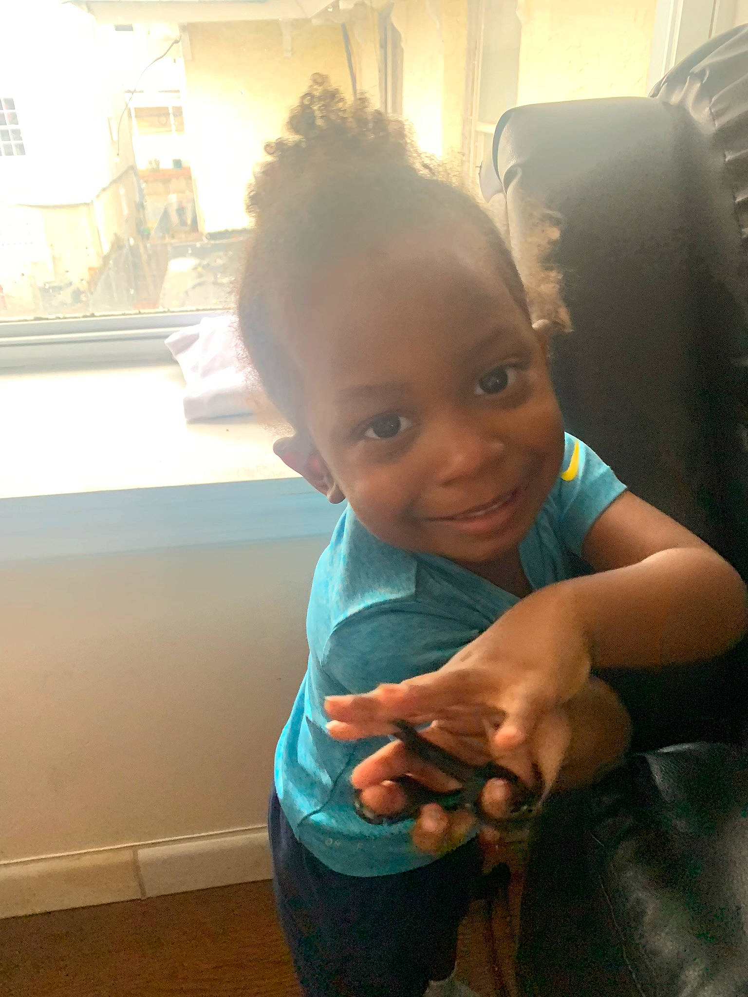 Zakai is registered to the contest to win money with this photo: black_hair, child, chin, cloud, eyebrow, finger, flooring, fun, happy, joy, leisure, morning, nose, person, room, sandal, sitting, skin, smile, thumb