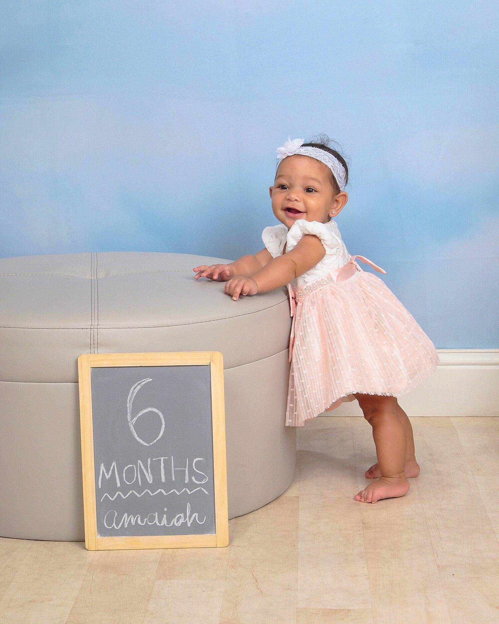 Amaiah is registered to the contest to win money with this photo: baby, baby_products, child, dress, footwear, furniture, happy, person, photograph, photography, pink, product, room, shoe, skin, table, toddler