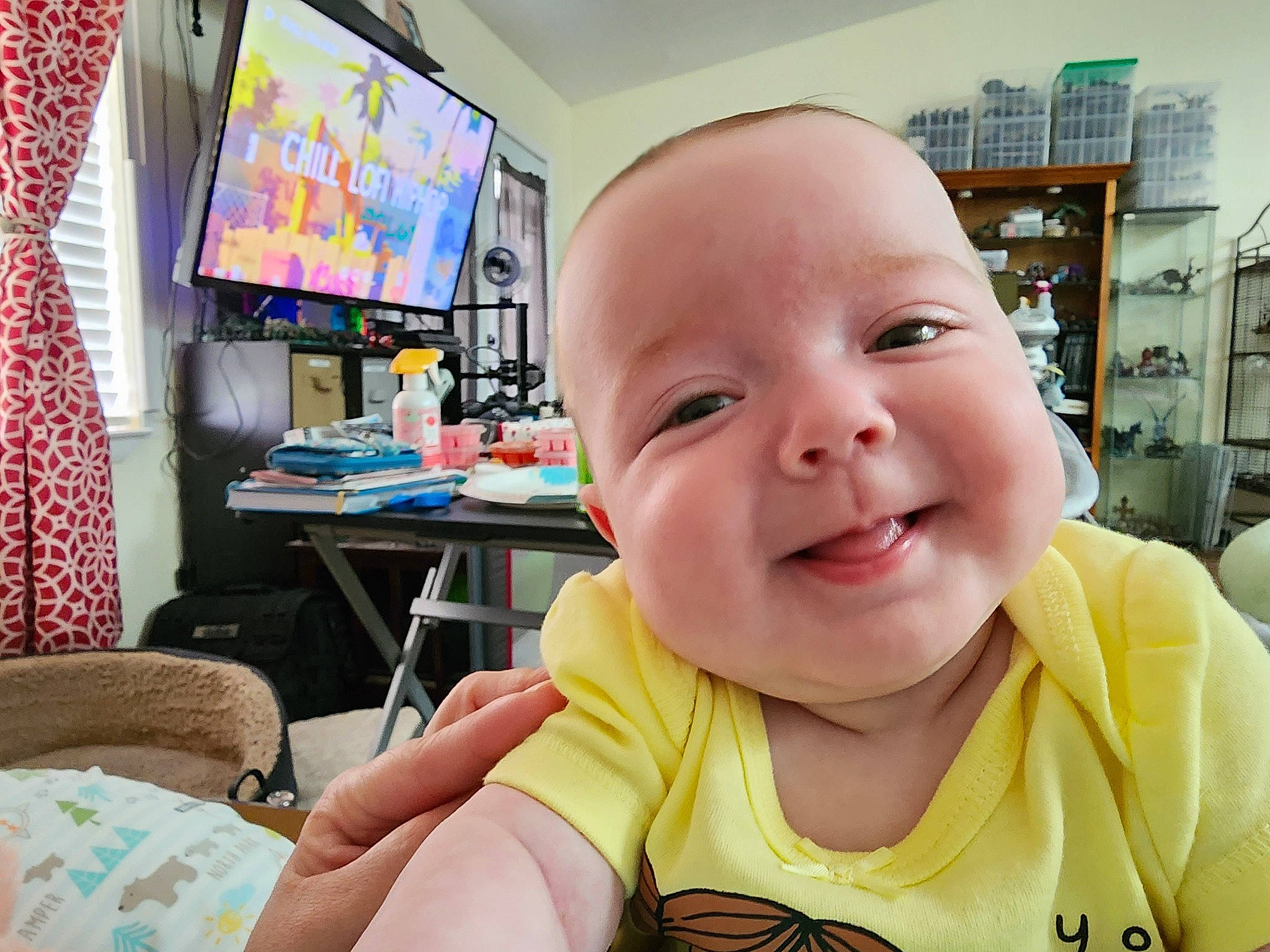 Madeline joined the competition — help win amazing prizes! baby, baby_laughing, baby_products, baby_toddler_clothing, cheek, child, curtain, eyelash, fun, happy, laugh, nose, person, photograph, room, shelf, sitting, smile, t_shirt, television