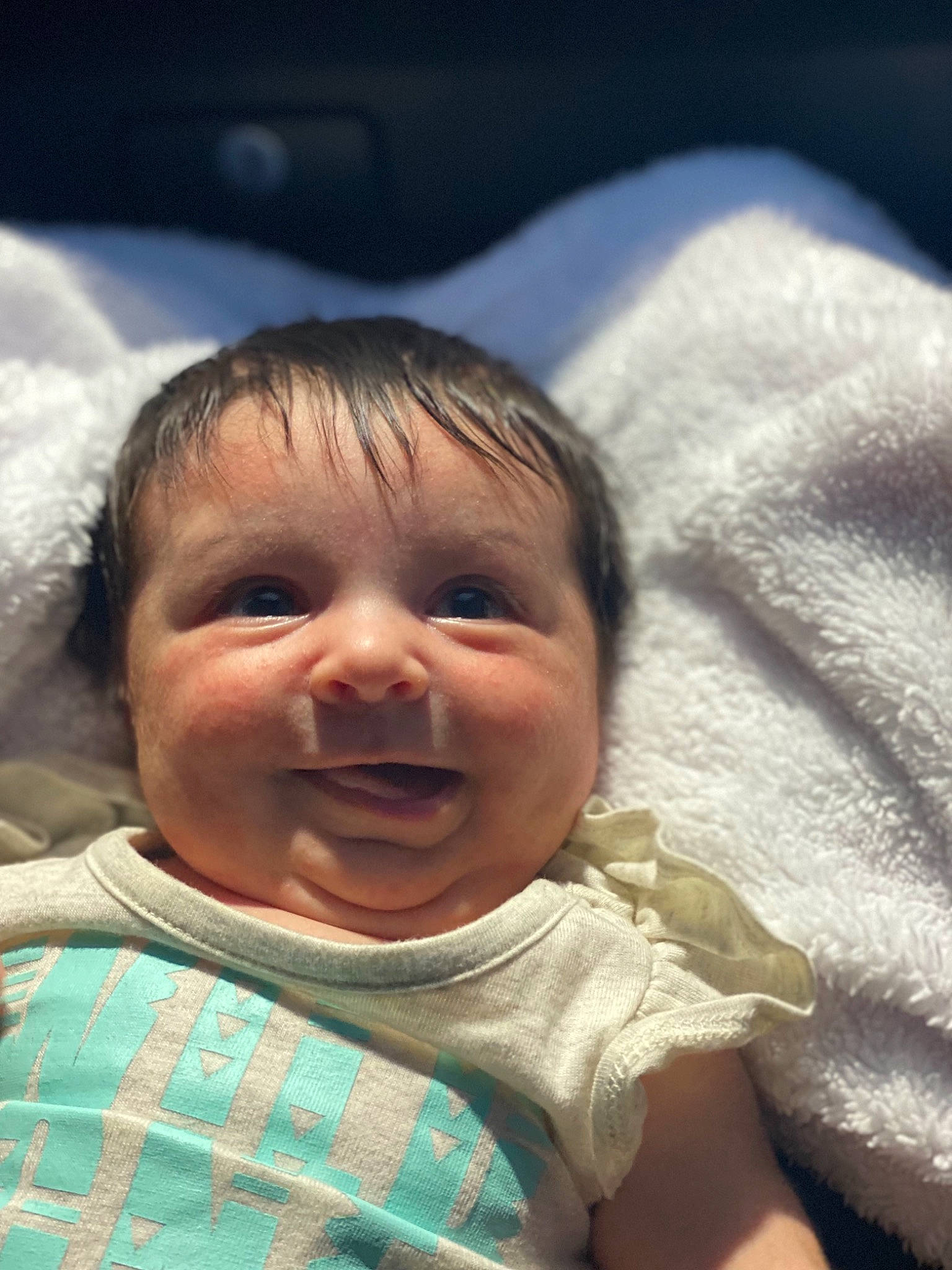 Addison is registered to the contest to win money with this photo: baby, baby_toddler_clothing, cheek, child, chin, comfort, eye, face, fun, happy, head, iris, joy, linens, lip, mouth, nose, person, skin, sleeve