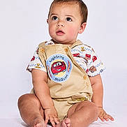Jaxxton is registered to the contest to win money with this photo: toddler, child, baby, sitting, clothing, shorts, shirt, lightning_mcqueen, cartoon, cute, studio, portrait, barefoot, expression, face, hands, legs, footwear_free, curious, innocent