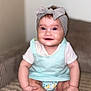 baby, blue_eyes, bow, child, chubby_arms, closeup, couch, cozy, cute, diaper, happy, headband, indoor, infant, mint_green_dress, person, portrait, sitting, smiling, soft_lighting
