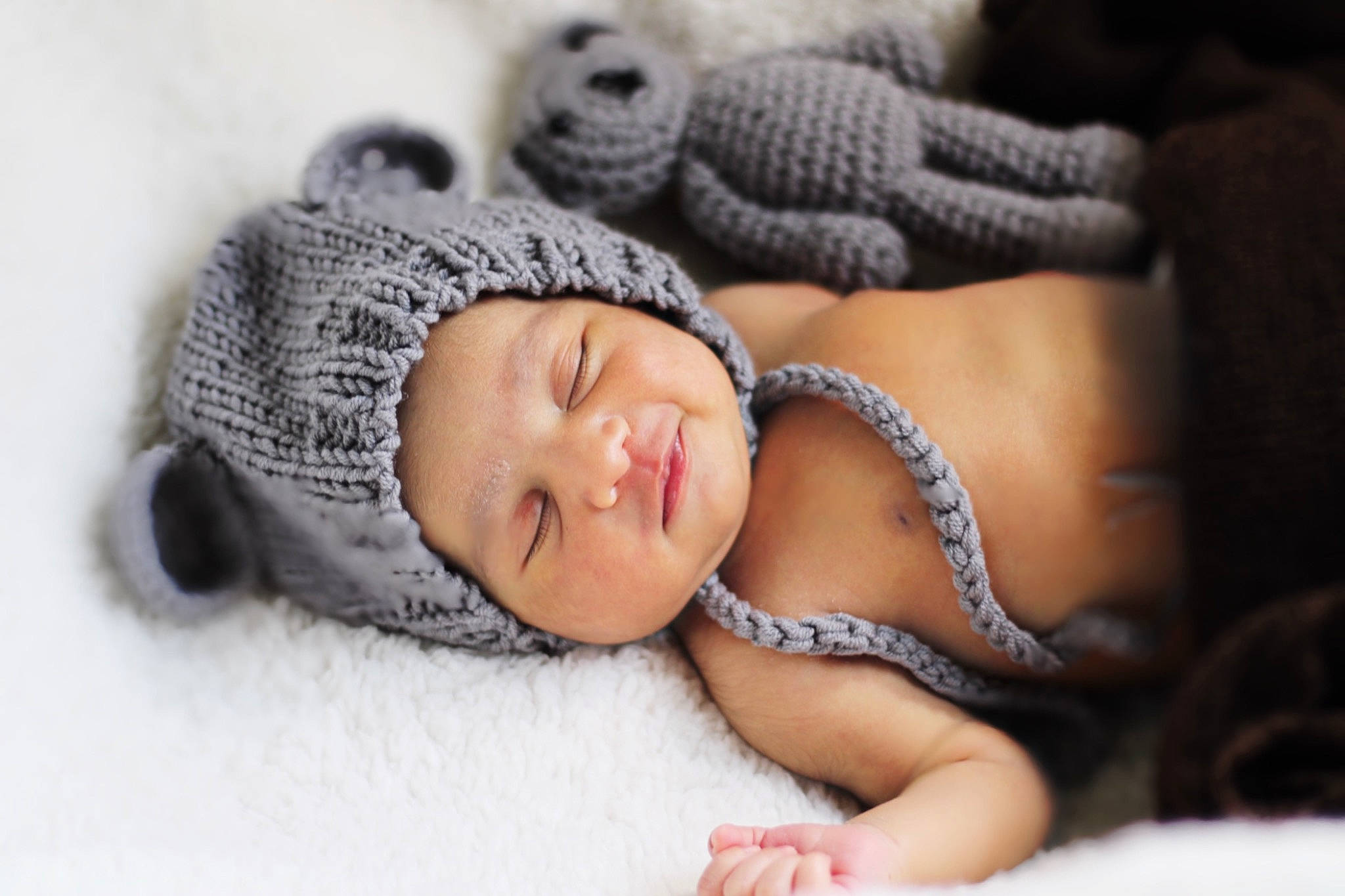Varalika is registered to the contest to win money with this photo: art, baby, baby_sleeping, cap, comfort, crochet, eye, eyelash, fawn, fur, grey, headgear, headwear, jewellery, knit_cap, linens, nail, pattern, person, toy