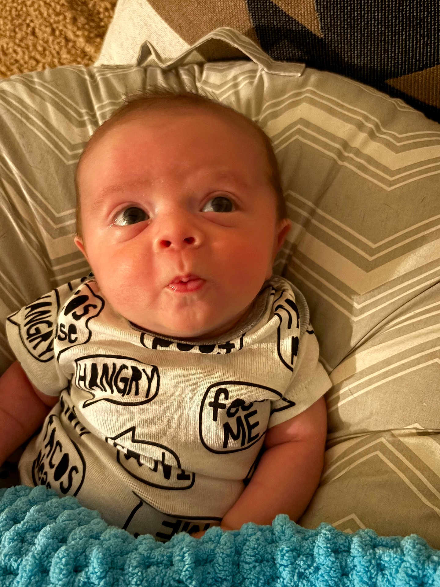 Michael joined the competition — help win amazing prizes! baby, infant, face, eyes, clothing, onesie, text, blanket, cushion, comfort, expression, curious, skin, head, person, cute, indoors, portrait, newborn, soft