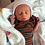 Michael joined the competition — help win amazing prizes! newborn, baby, infant, sleeping, blanket, hat, striped_clothing, cozy, cute, indoors, swaddled, person, face, headwear, small_hands, resting, soft_light, peaceful, child, newborn_clothes