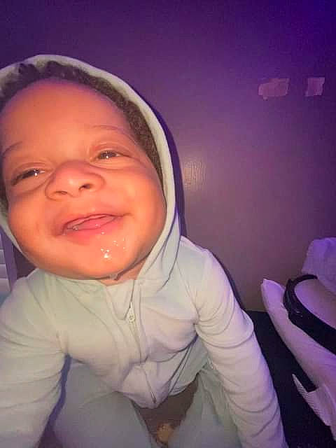 Khamari is registered to the contest to win money with this photo: baby_toddler_clothing, cheek, comfort, cool, eye, eyebrow, flash_photography, gesture, happy, human_body, iris, jaw, lip, mouth, neck, nose, person, purple, sleeve, smile