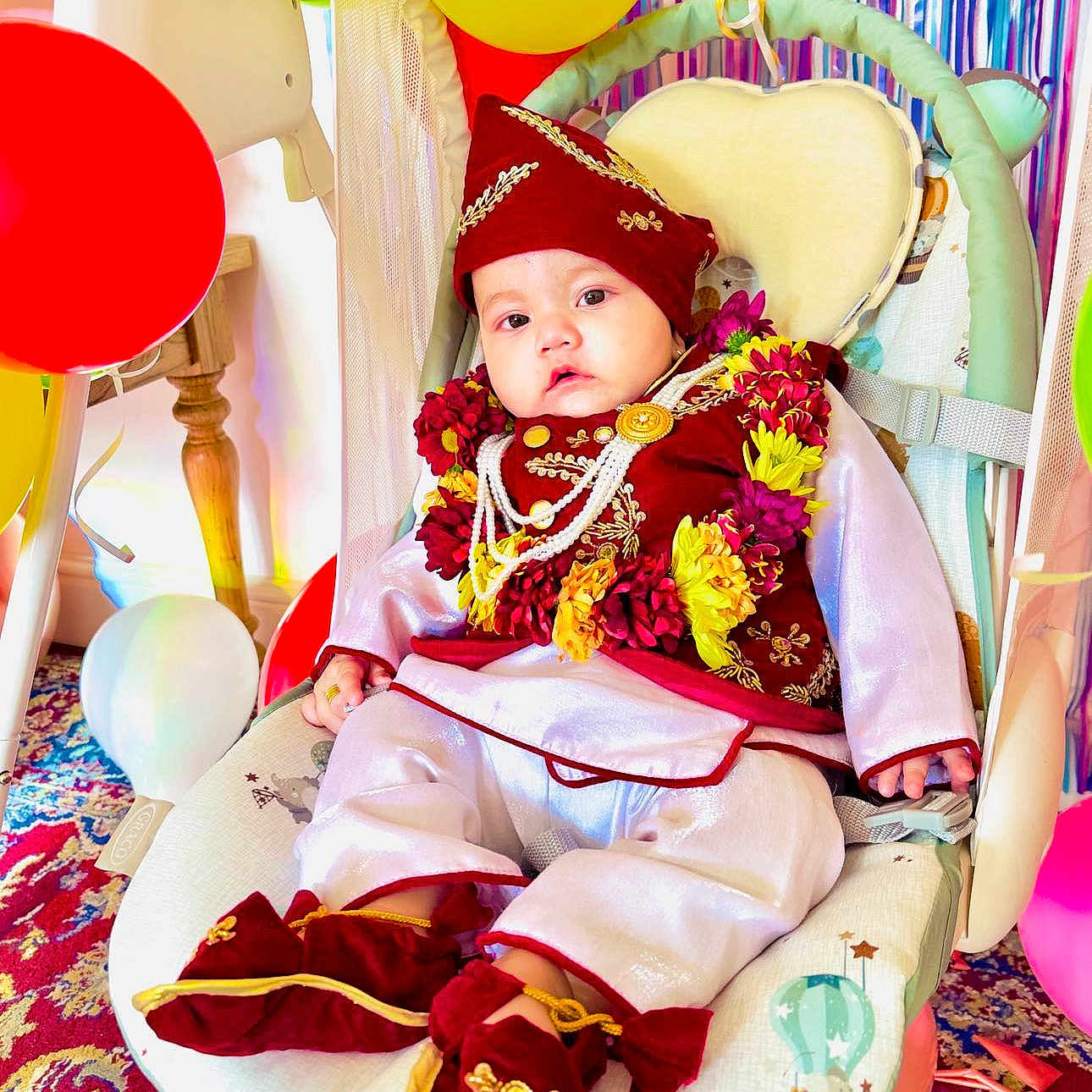 Aditya joined the competition — help win amazing prizes! baby, balloon, blanket, clothing, crib, face, festival, flower, flowerarrangement, flowerbouquet, furniture, hat, head, infantbed, people, person, plant, sitting