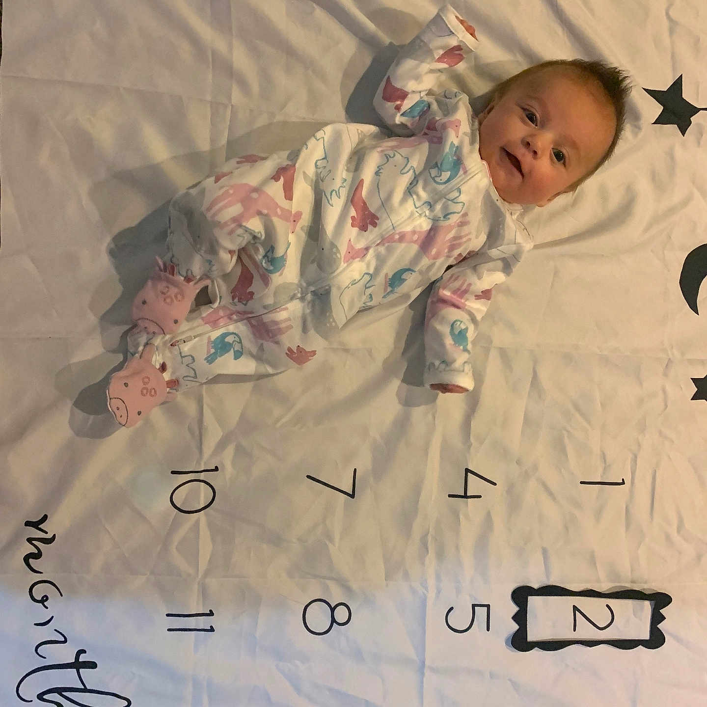 Mia is registered to the contest to win money with this photo: baby, bed, blanket, clothing, crib, cushion, document, face, furniture, head, homedecor, infantbed, newborn, number, pajamas, person, photography, portrait, quilt, sitting