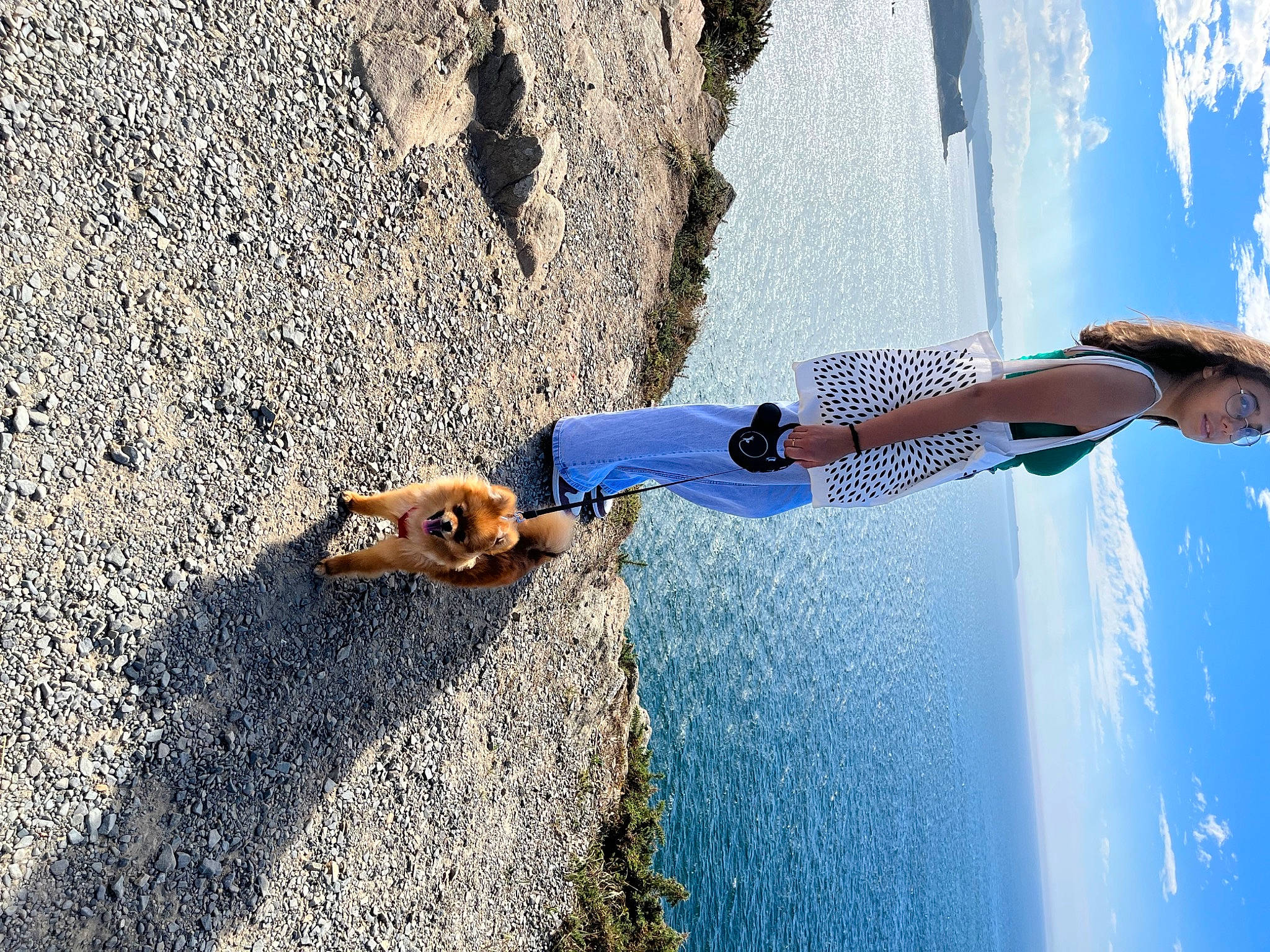 Tika participe au concours pour gagner de l'argent avec cette photo : adventure, asphalt, azure, denim, dog, dress, electric_blue, eyewear, fun, human_body, human_leg, landscape, leg, leisure, recreation, road_surface, shadow, sky, travel, water