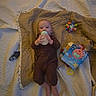 baby, blanket, bottle, child, colorful, comfort, cute, feeding, floor, indoor, infant, lying_down, onesie, person, play, quilt, resting, soft_lighting, toy, young